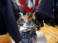 Stitchers are seen making suit jackets under a conveyor belt system that eases the transportation between stations, at the Joseph Abboud manufacturing plant in New Bedford, MA.   [ PETER PEREIRA/THE STANDARD-TIMES/SCMG ]